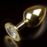 Большая золотистая анальная пробка с прозрачным кристаллом - 9 см.