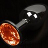 Графитовая анальная пробка с оранжевым кристаллом - 8,5 см.